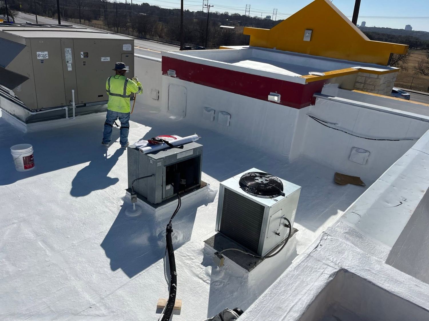 Crew applying commercial coating